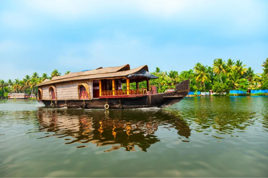 A traditional wooden houseboat floating peacefully on a calm backwater